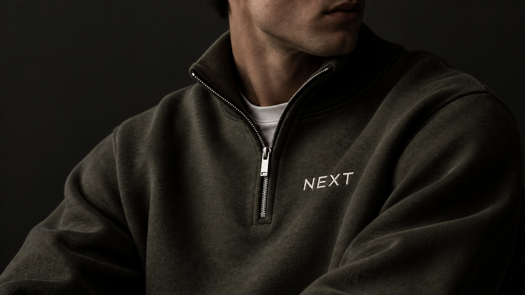 Model wearing the olive NEXT quarter-zip